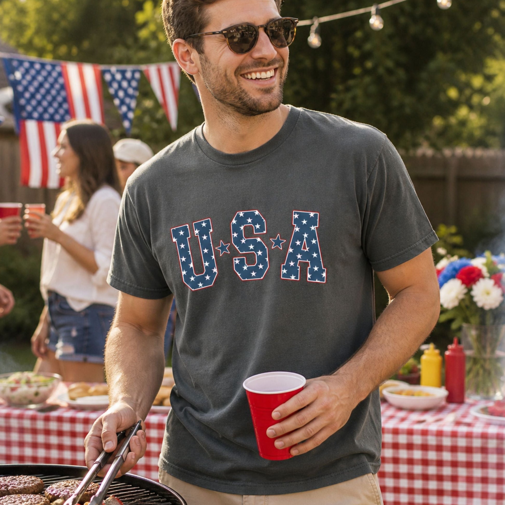 Man at a barbeque wearing a USA shirt.